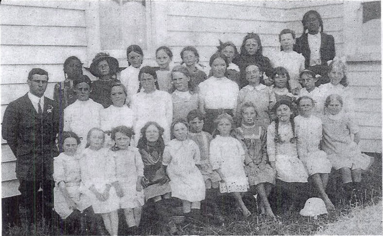 picture of teacher and pupils taken outside old public hall, 1914